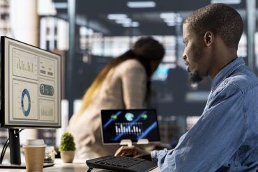 Male entrepreneur conducting financial planning and goal setting, demonstrating expertise in budget management. CEO analyzing online reports and forecasts to drive company growth plans.